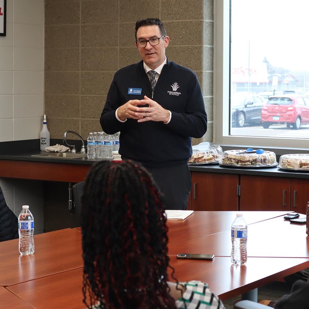 Superintendent Cory McIntyre visits with students at Coon Rapids High School