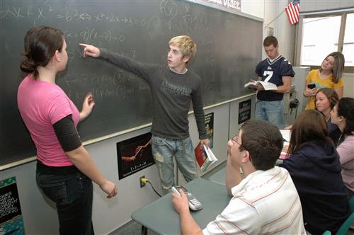 students working together at the blackboard