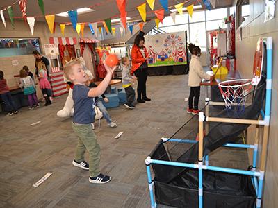 first grade boy shooting a small basketball