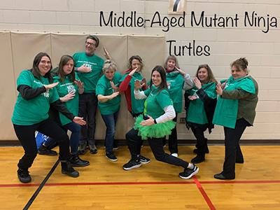 group of people in green shirts