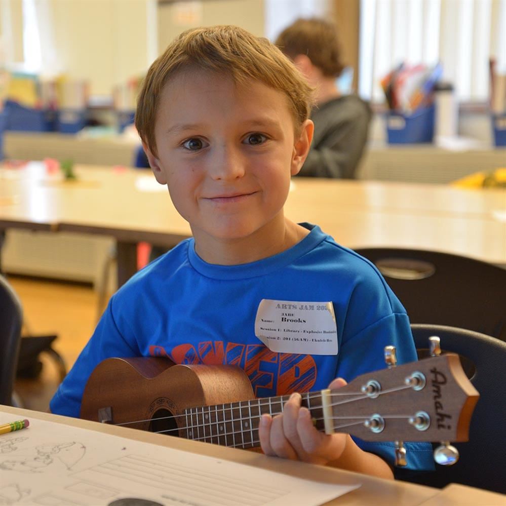  student holding a ukulele 