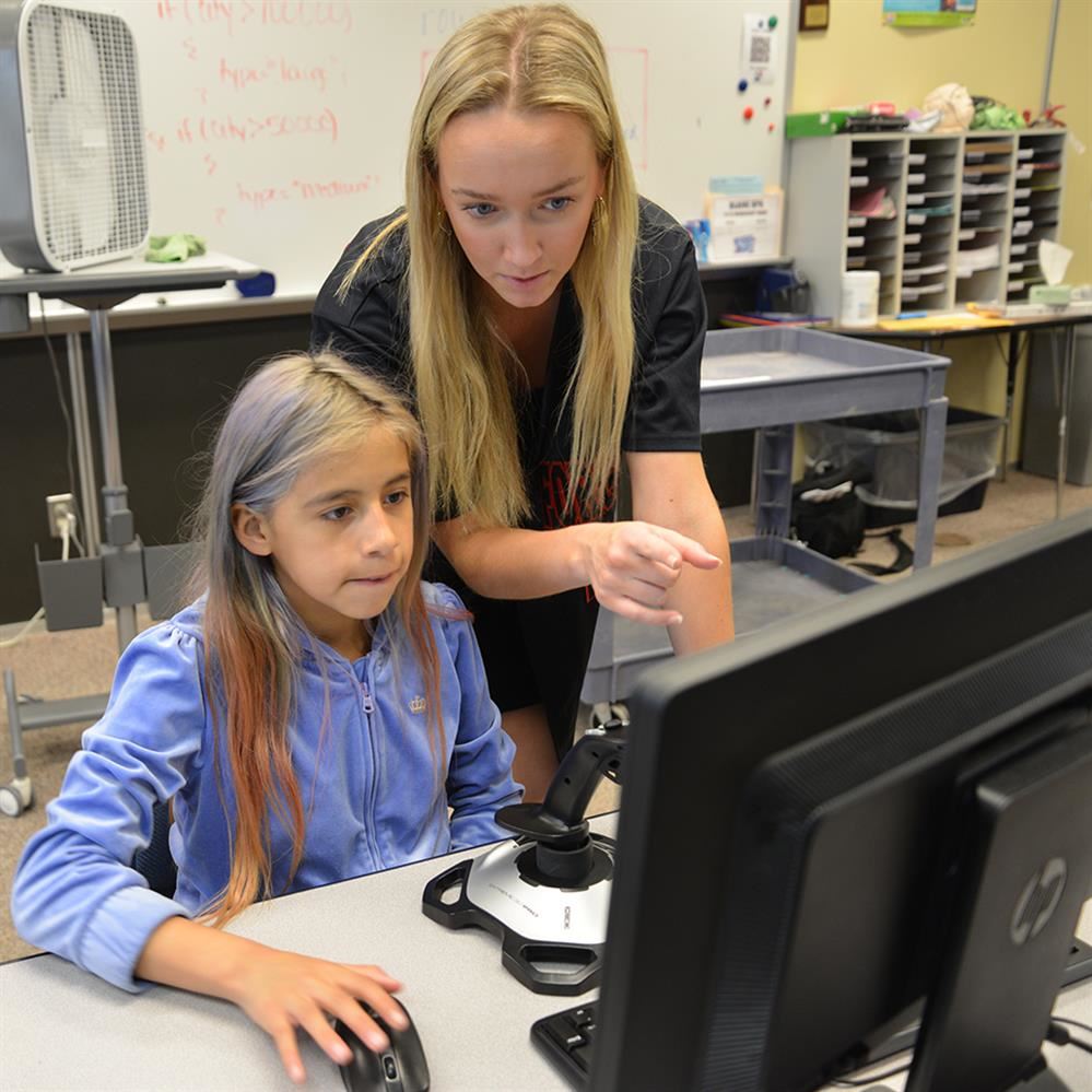  BHS student at a computer with University Ave student
