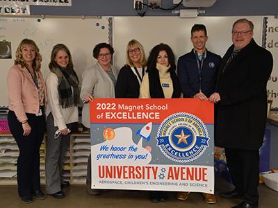 Magnet School of Excellence group photo with banner