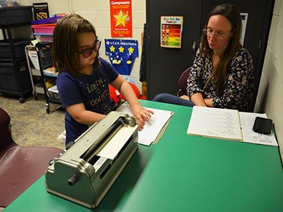 Sloan Peterson reading braille