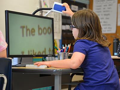 Sloan Peterson using a device to read the board