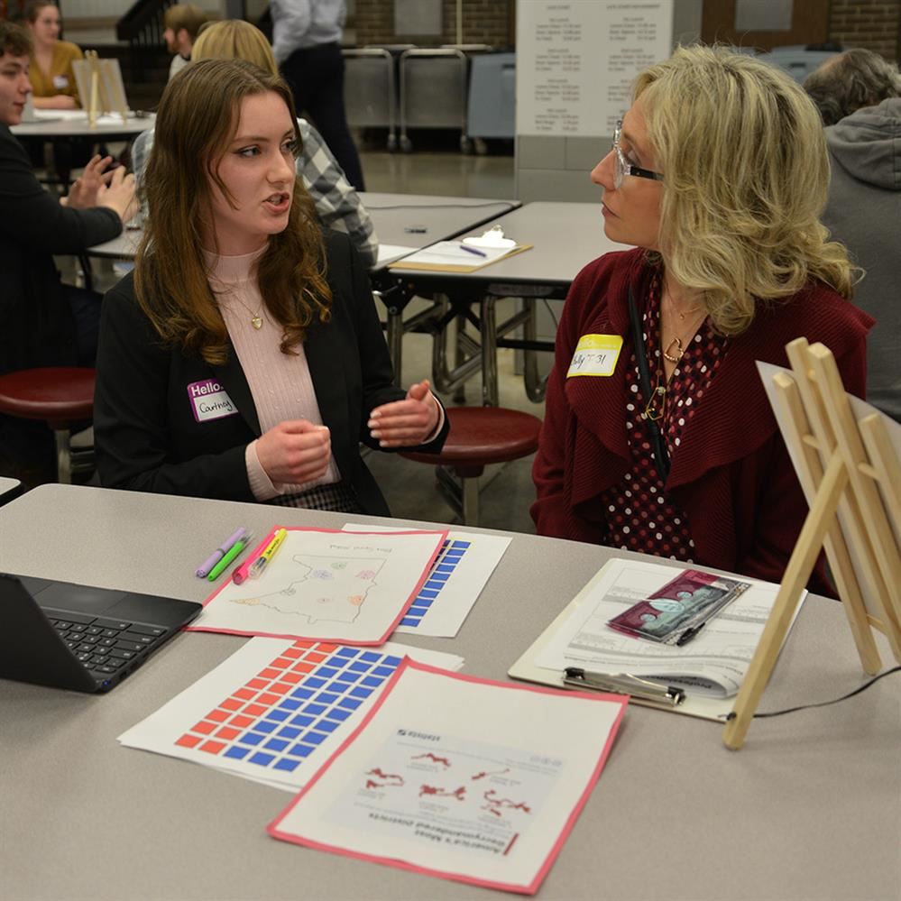 student and reviewer talking