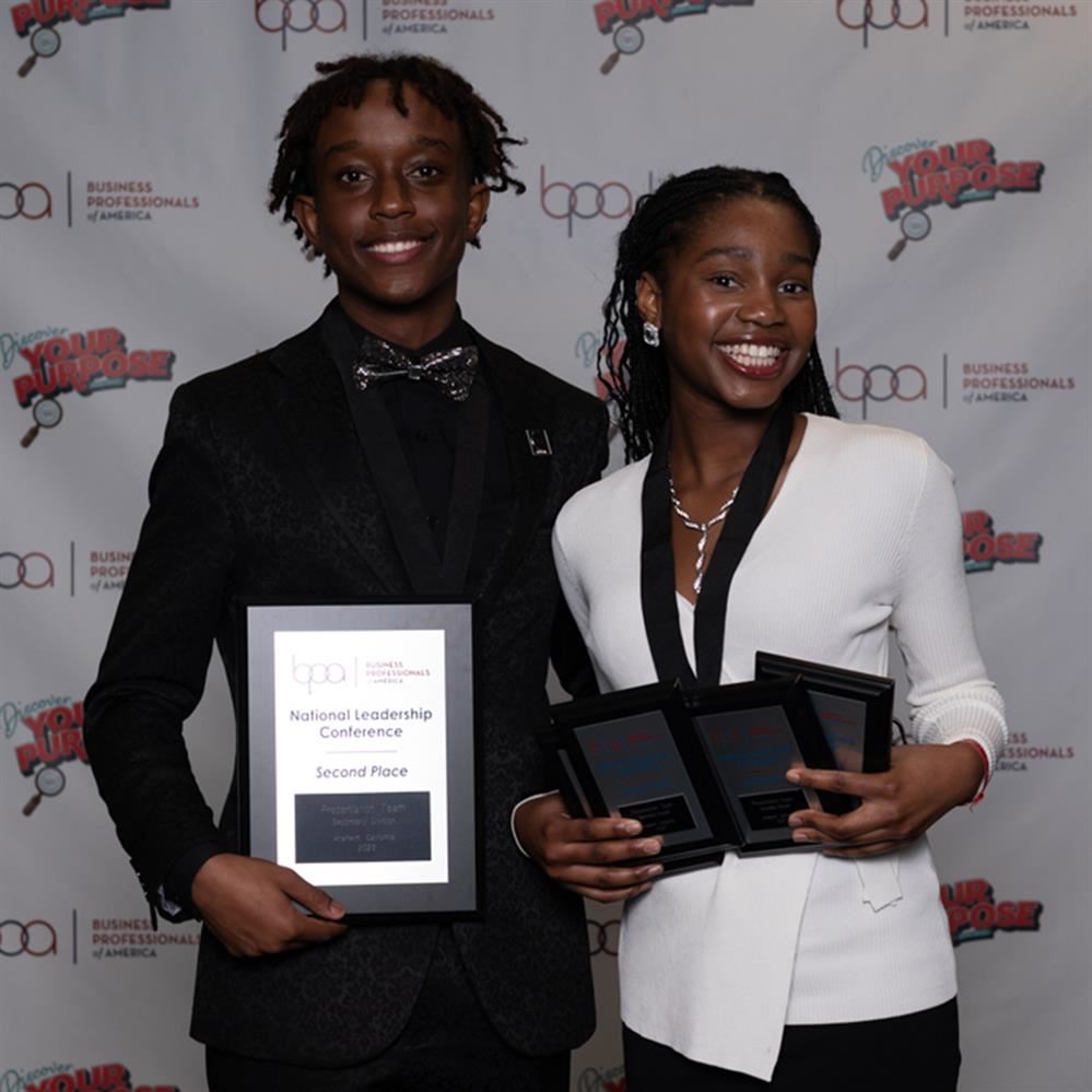 Silas Murangiri and Dorcas Aroloye posing with plaques