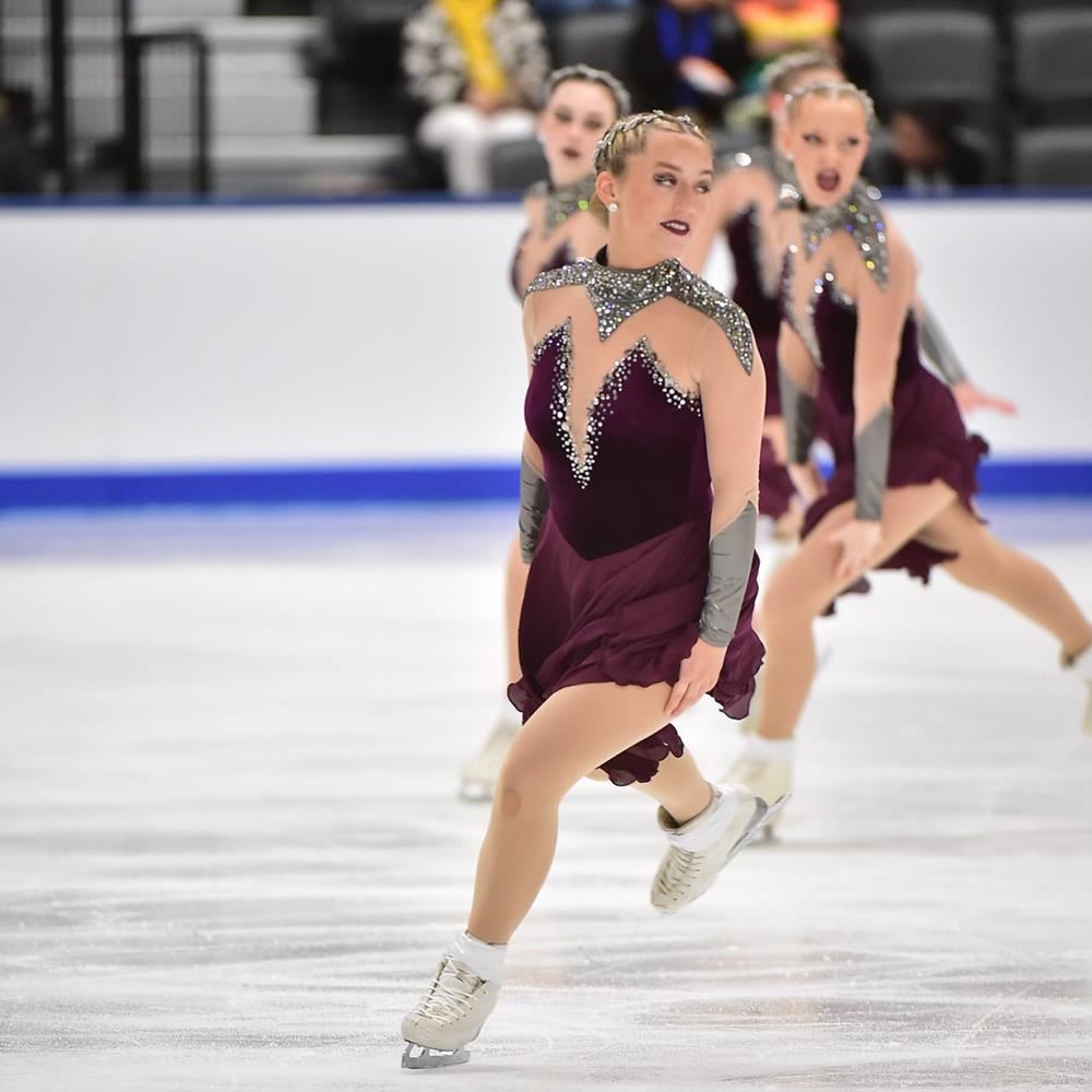  Olivia skating with teammates in the background