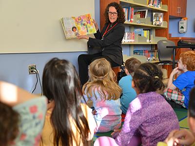 Maguire reading to kids