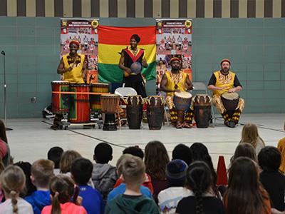 students watching drum performance from West African group