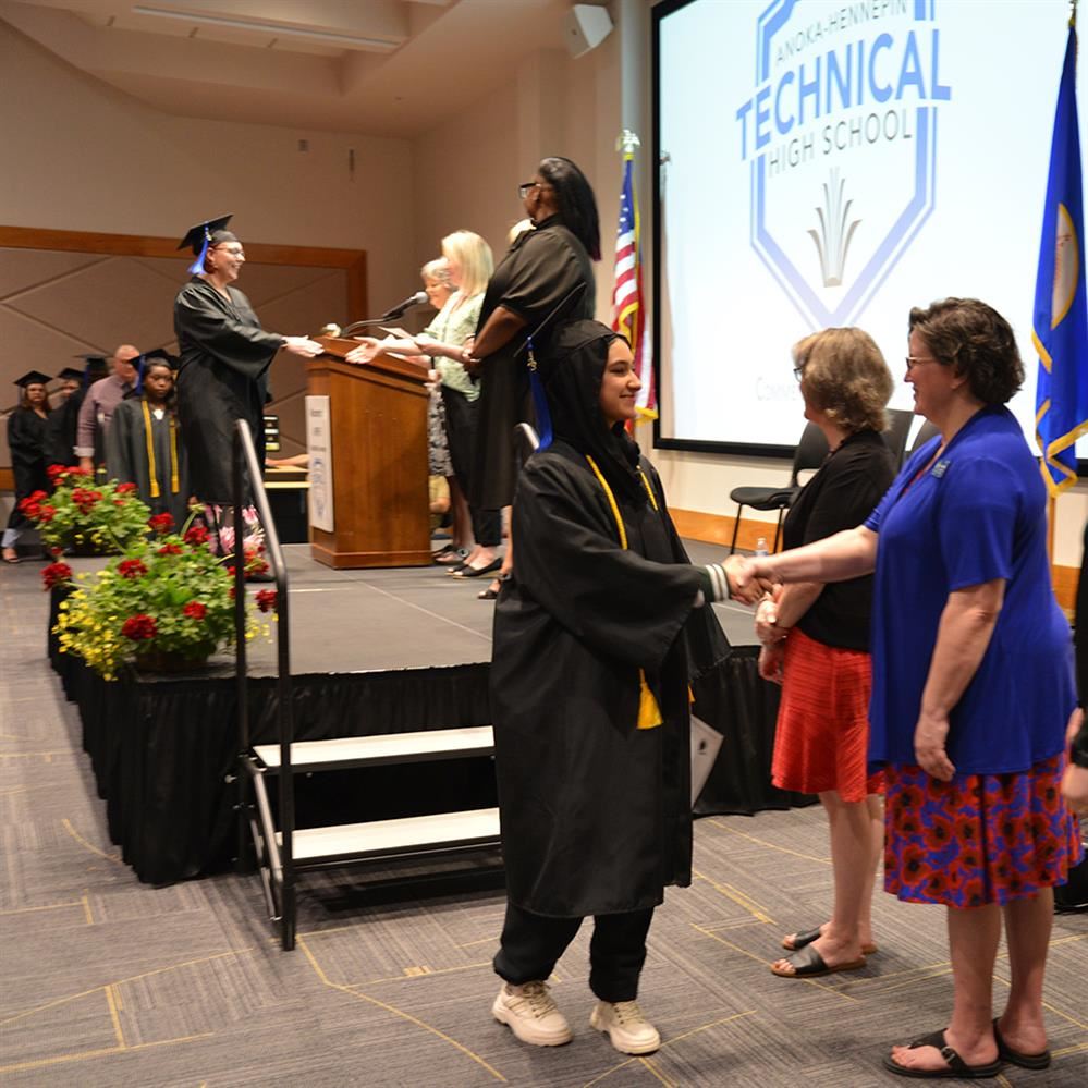  Graduate shaking hands with board member