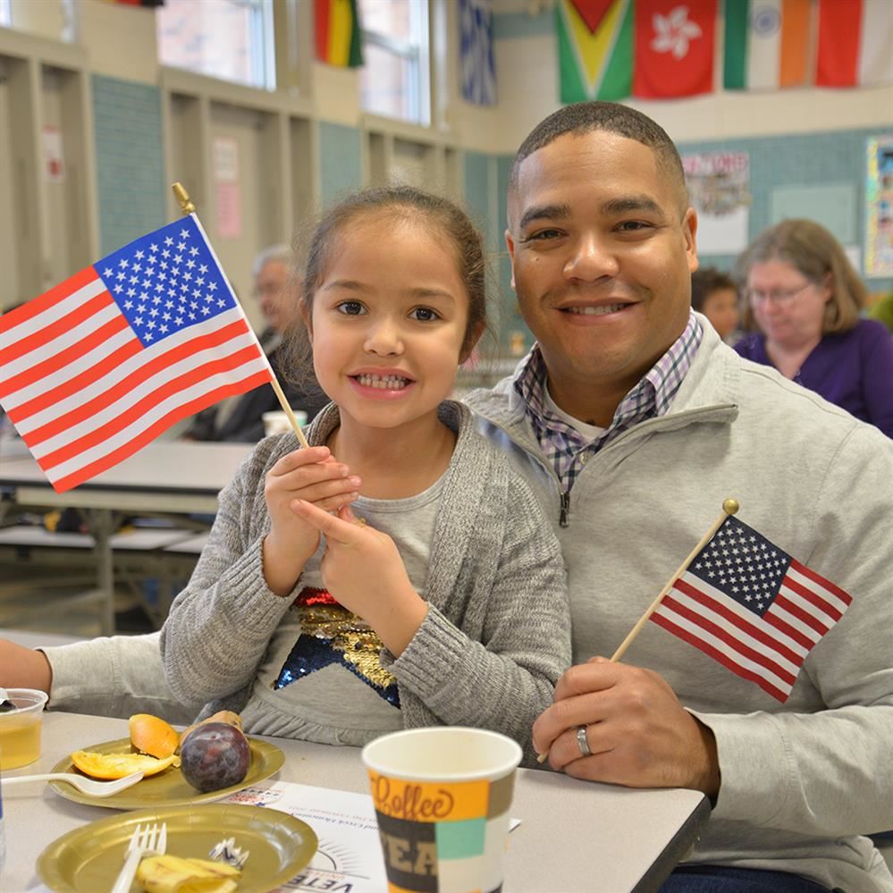  student and father holding American flags 
