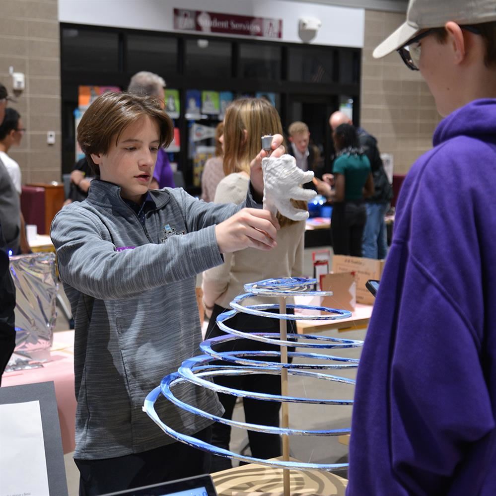  student demonstrating his project