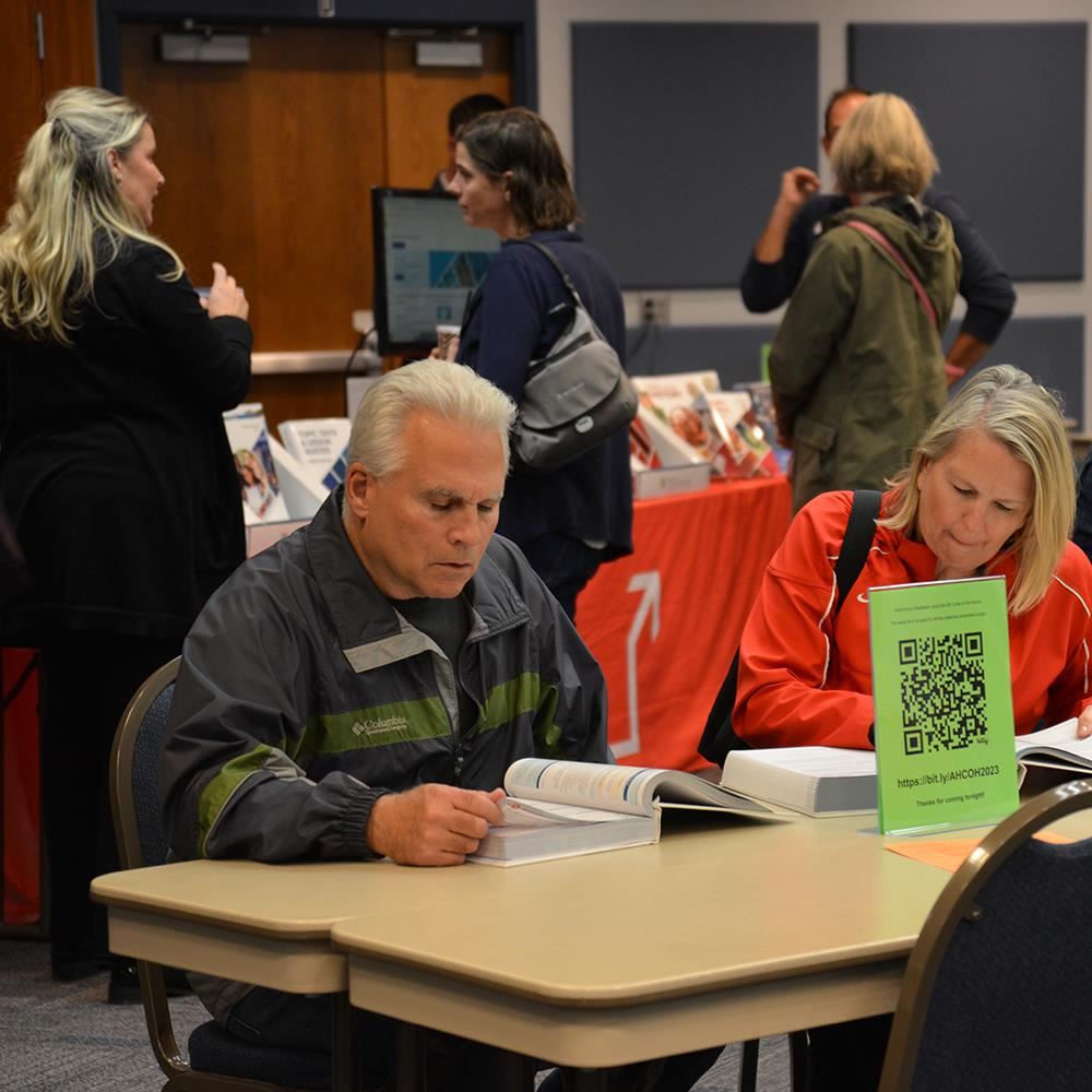 two people reading textbooks