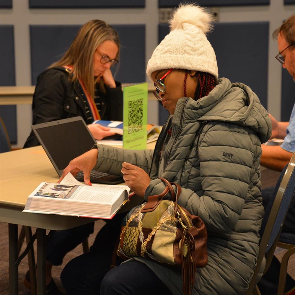  woman looking at a text book