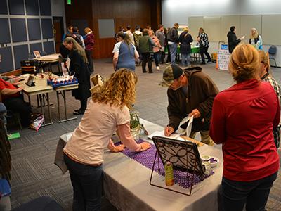 groups of people at different vendor tables 