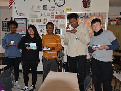 students holding their creations 