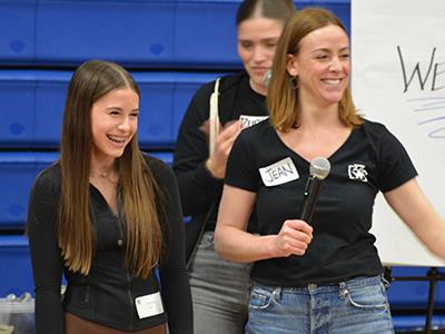 student laughing with YF leader holding a mic