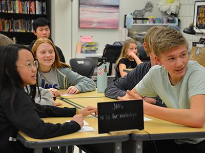 students smiling and answering a question