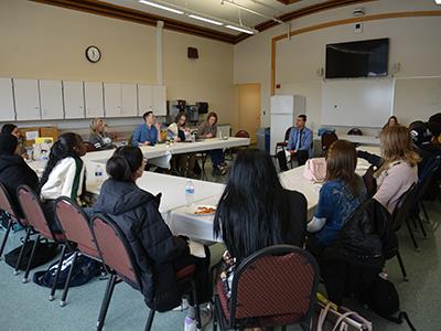 students and staff sitting in a horseshoe