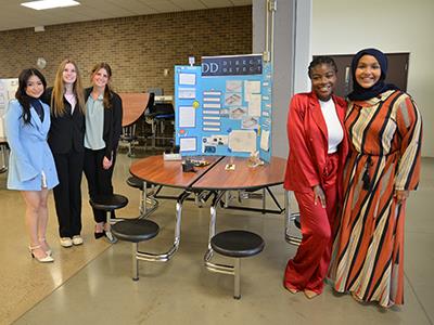 five women posing with project