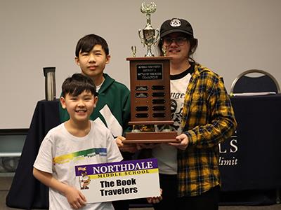 winning team - three students with trophy