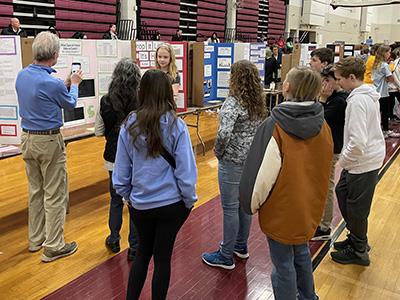 students and community members listening to student present project