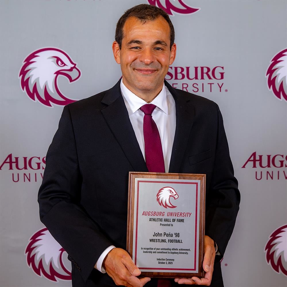  John Peña holding Augsburg Hall of Fame plaque