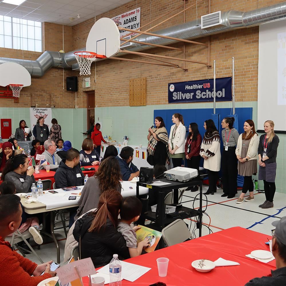  Adams staff sharing information with parents and guardians at the English Learner family event