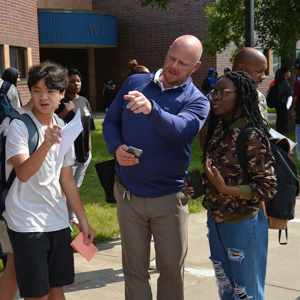  CPHS principal Mike George helps students locate their bus after the first day of school in 2022
