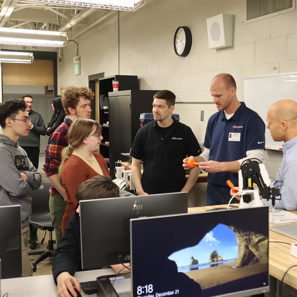  CRHS engineering students share their new device with representatives from Aggressive Hydraulics