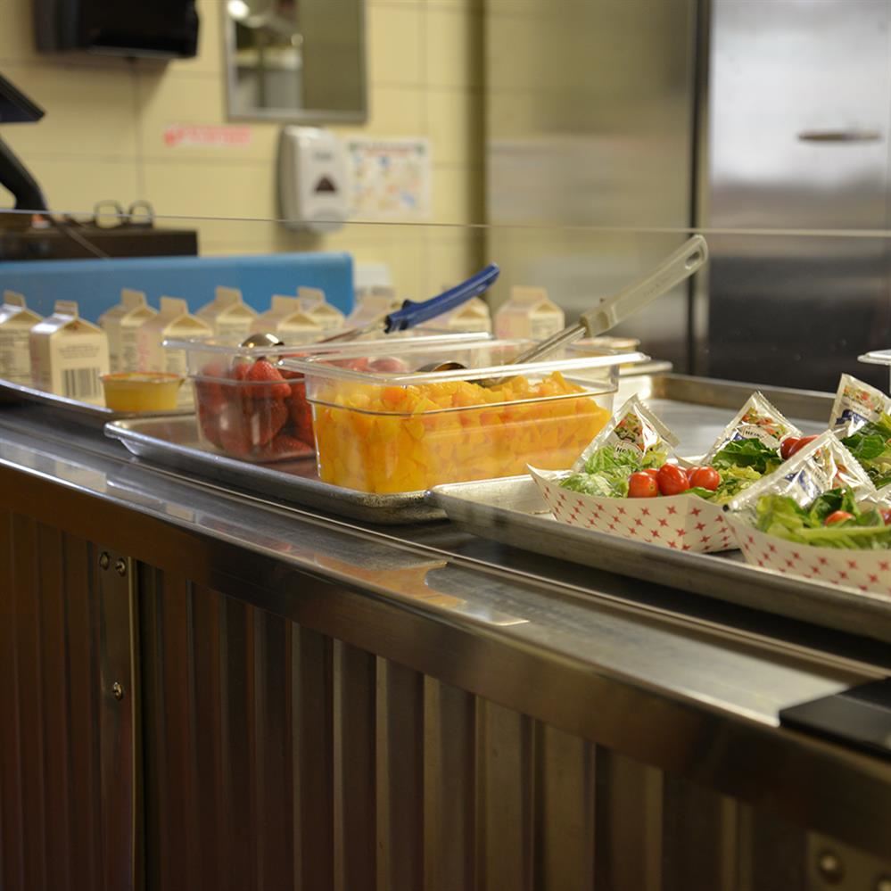  Food set up on a counter in a school cafeteria line