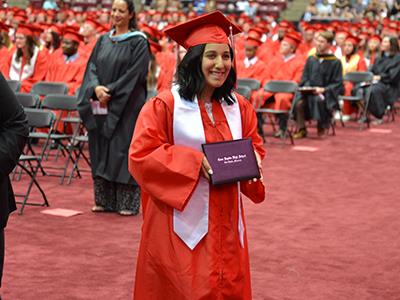 Coon Rapids High School senior poses with diploma at graduation ceremony