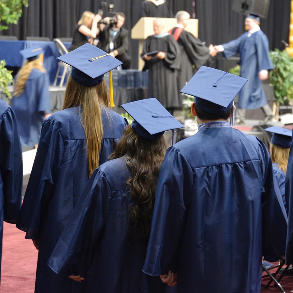  Champlin Park High School graduates make their way to the stage for their diplomas