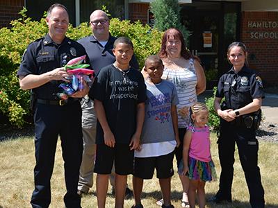 Hamilton fourth grader Jarius Koch pictured with his family and CRPD officers