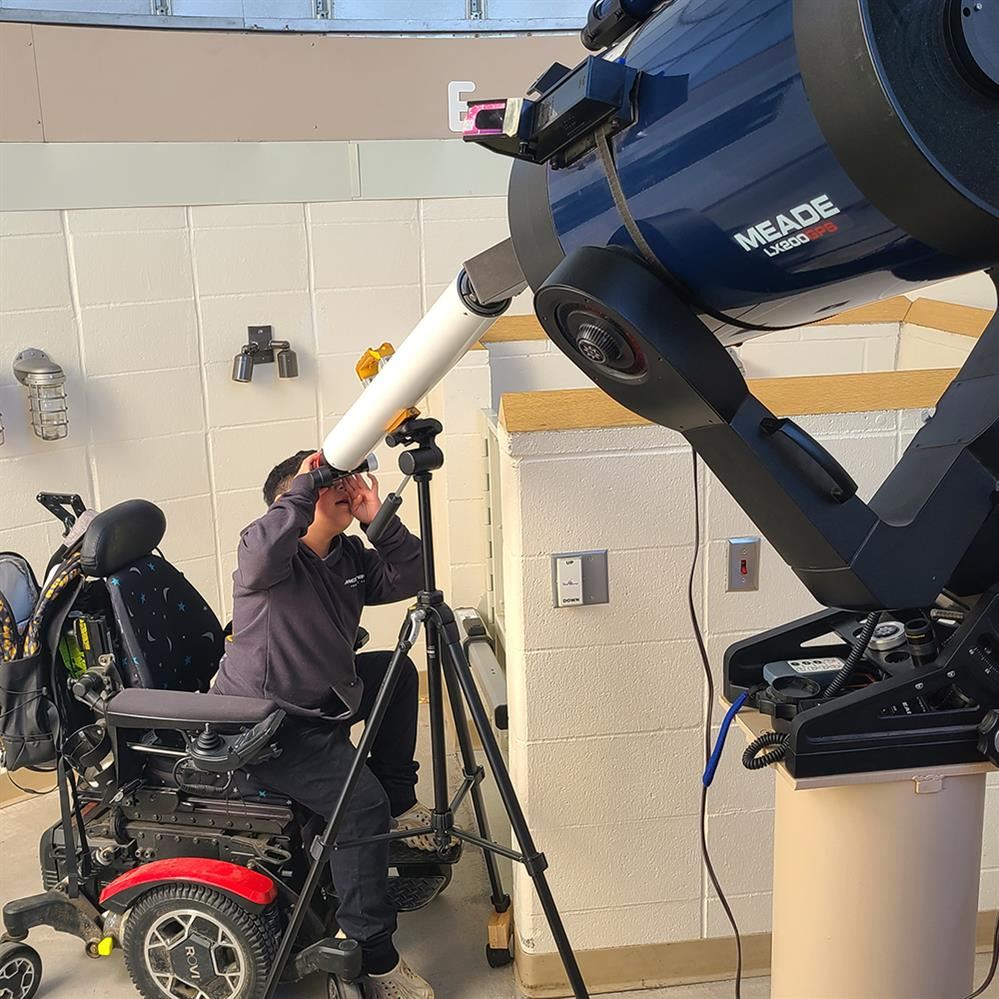 Jackson Middle School student viewing through the telescope at the Observatory 
