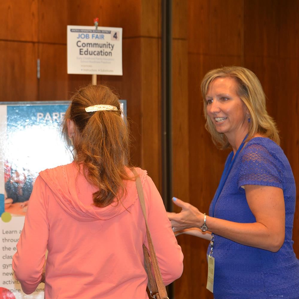  Job seeker visiting with a hiring manager at a past district job fair