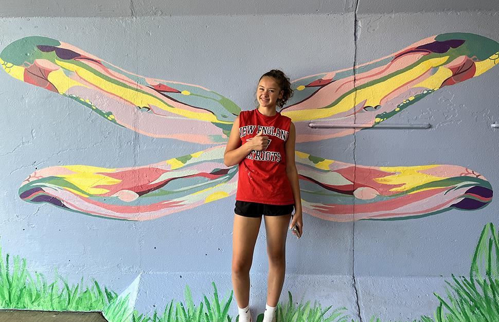 Andover High School student Rachel Kroona pictured in front of her artwork in downtown Anoka