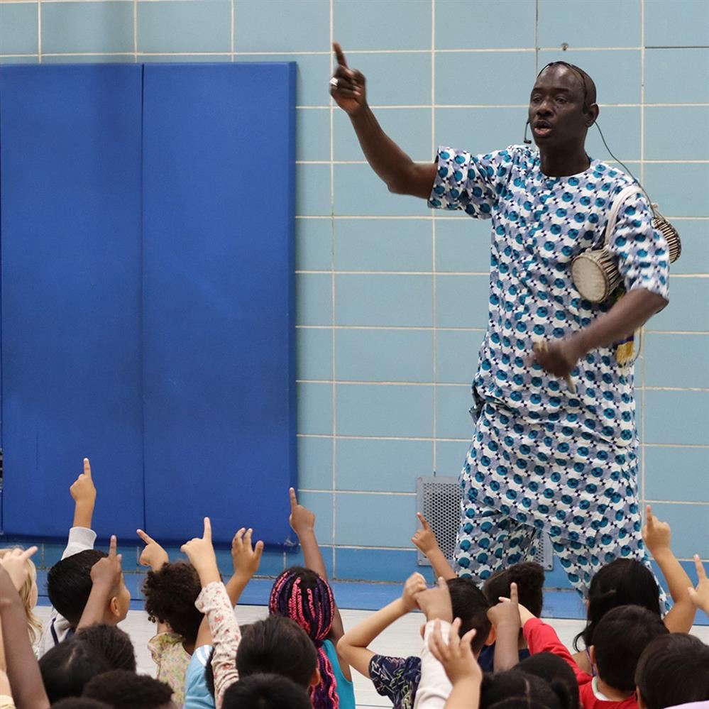 Massamba Diop performs and asks for crowd participation at Evergreen Park Elementary