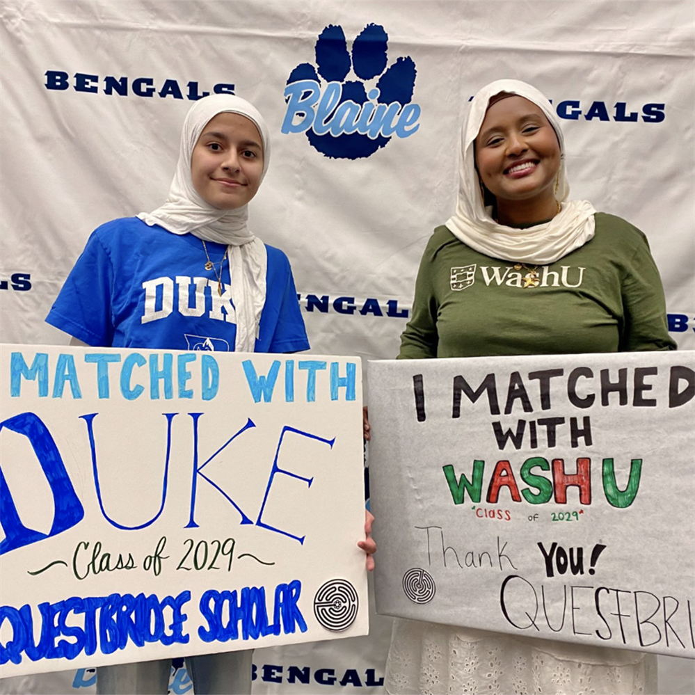  Nawal Arafa and Sarrah Es-Sabha holding signs of their college choices