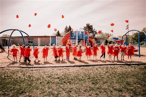 young graduates tossing caps