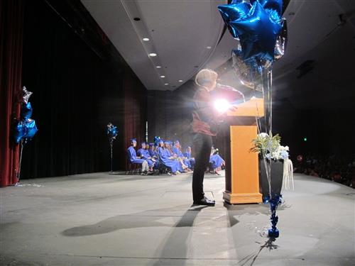 Graduates wait on stage at ceremony 
