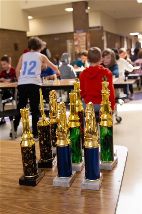 Chess tournaments with kids in background