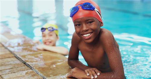 Children in pool smiling 