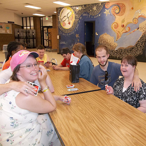  Adults with special needs playing Uno.