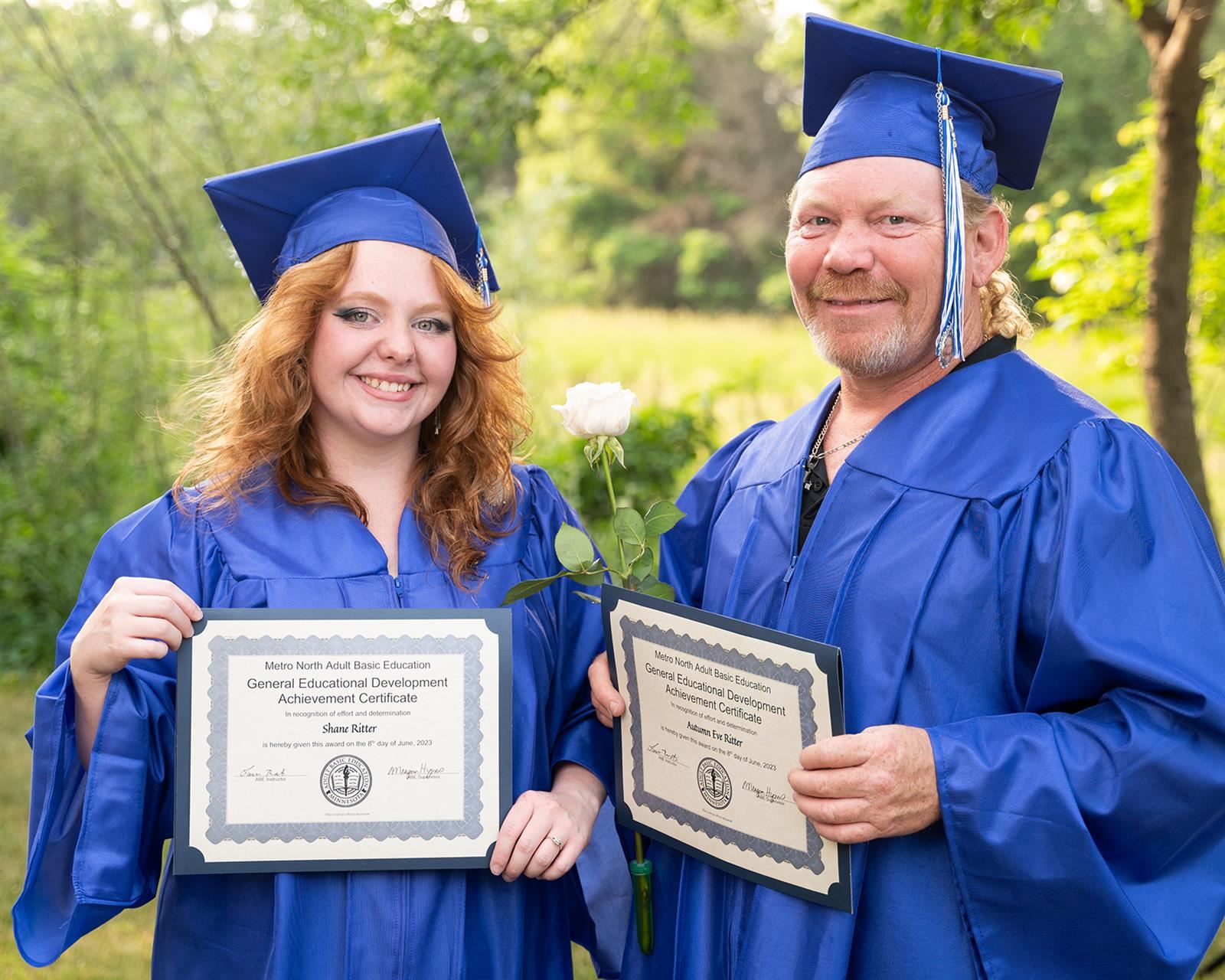father and daughter with diplomas