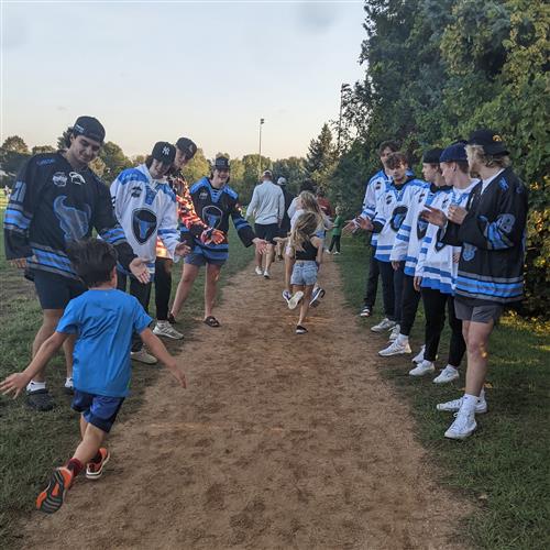 Hockey players cheering on students