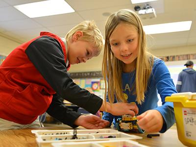 students building with LEGOs