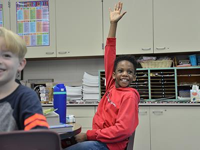 student raising their hand